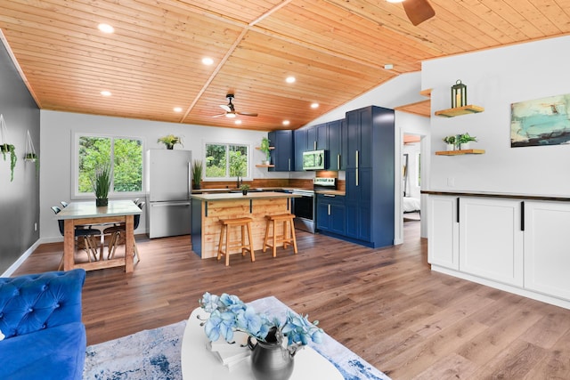 living area with wooden ceiling, ceiling fan, wood finished floors, recessed lighting, and vaulted ceiling