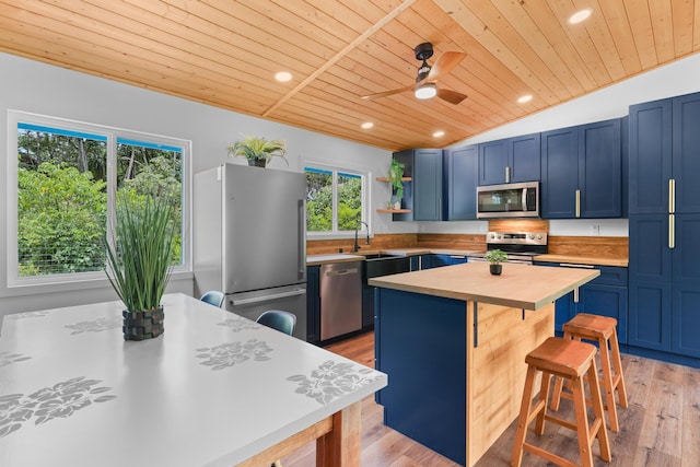 kitchen with appliances with stainless steel finishes, wooden ceiling, blue cabinets, wooden counters, and open shelves