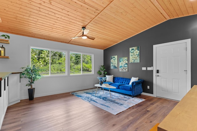 living room featuring wooden ceiling, lofted ceiling, a ceiling fan, light wood-style flooring, and baseboards