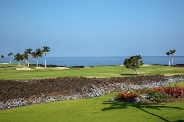 surrounding community with a water view, golf course view, and a yard