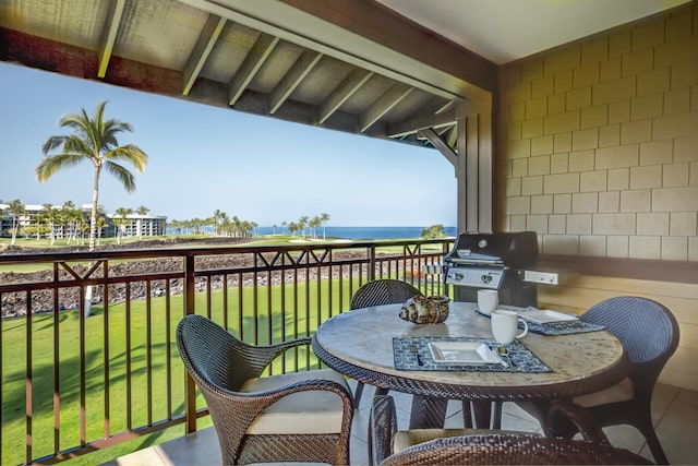 balcony featuring a water view, grilling area, and outdoor dining space