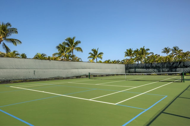 view of tennis court with fence and community basketball court