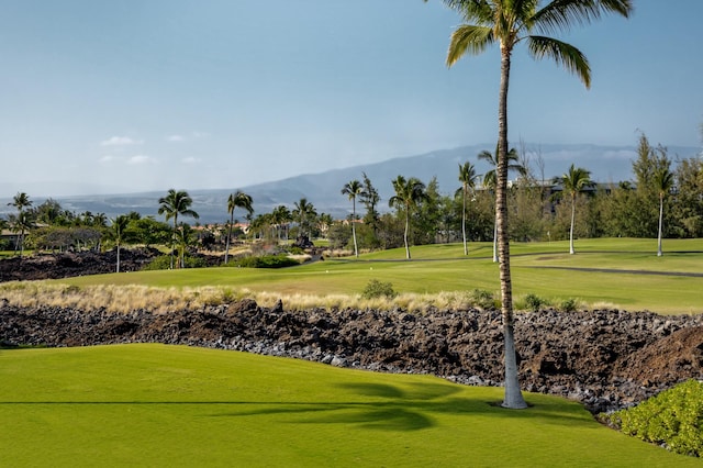 view of community with a lawn, a mountain view, and golf course view