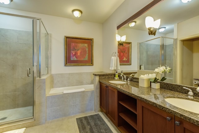 full bathroom featuring a garden tub, a sink, tile patterned flooring, and a shower stall