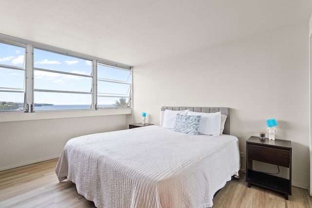 84 Pukihae St Unit 802, Hilo, HI 96720 - bedroom featuring a water view, baseboards, and wood finished floors