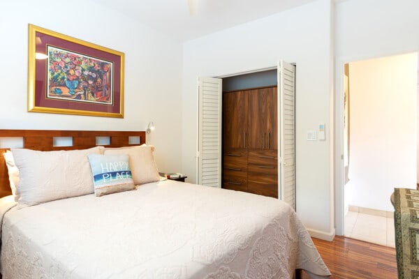 bedroom featuring baseboards, a ceiling fan, and wood finished floors