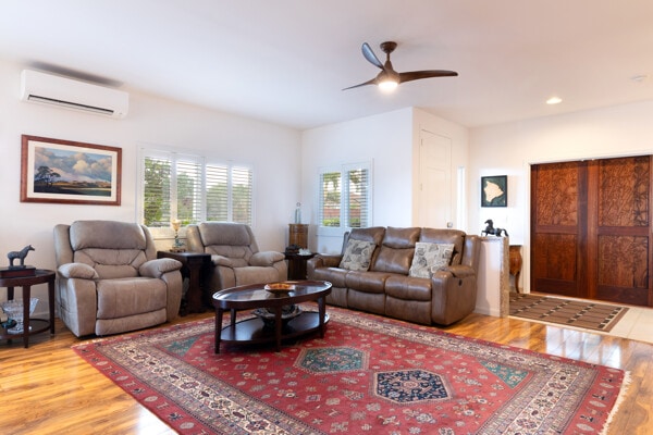 living room with wood finished floors, recessed lighting, ceiling fan, and a wall mounted AC