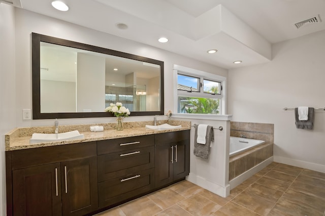 2326 Wiliko St, Lihue, HI 96766 - bathroom with double vanity, a bath, visible vents, a sink, and baseboards