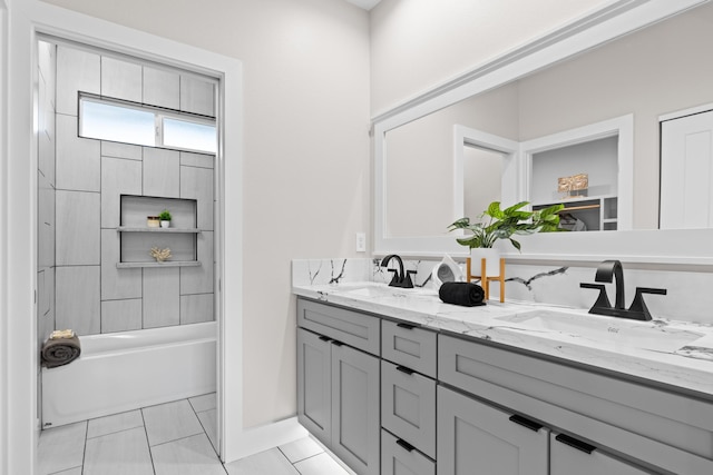 bathroom featuring double vanity and shower / bath combination