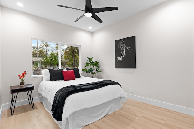 bedroom with wood finished floors, recessed lighting, baseboards, and ceiling fan