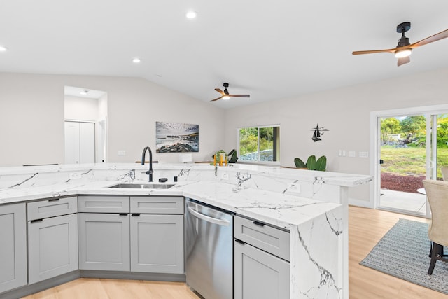 kitchen featuring stainless steel dishwasher, ceiling fan, gray cabinets, a sink, and vaulted ceiling