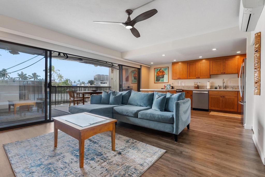 living area with an AC wall unit, a ceiling fan, recessed lighting, and a healthy amount of sunlight