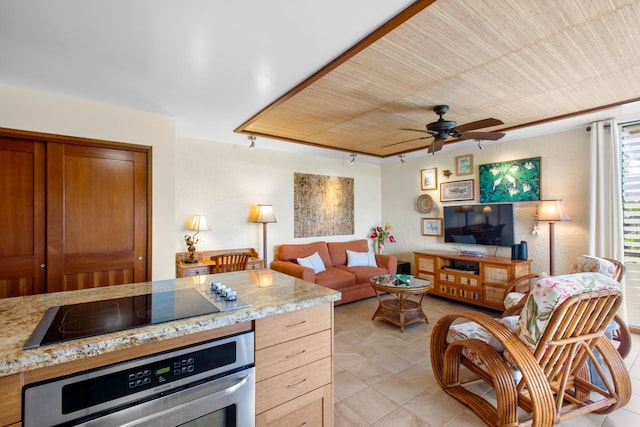 living area with wooden ceiling, a ceiling fan, and light tile patterned floors