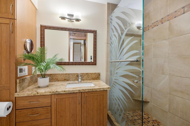full bath with a stall shower and vanity