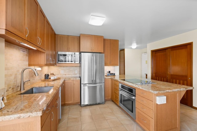 kitchen with light tile patterned floors, a sink, a peninsula, backsplash, and stainless steel appliances