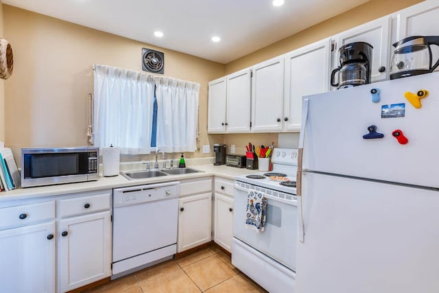 kitchen with recessed lighting, a sink, white appliances, light countertops, and white cabinets