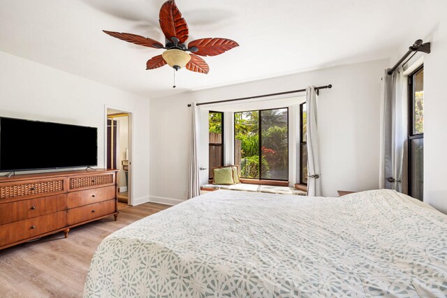 bedroom with baseboards, a ceiling fan, and light wood-style flooring