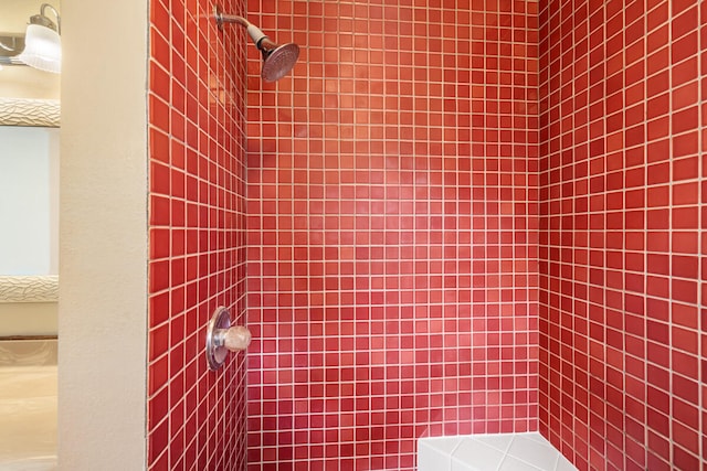 interior details with a tile shower