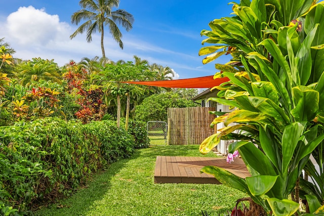 view of yard featuring fence and a wooden deck