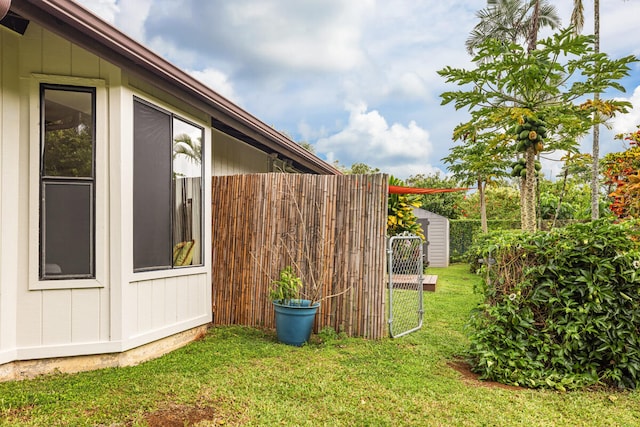 view of property exterior featuring a gate, fence, and a yard