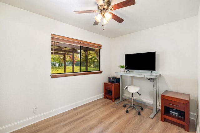 office space featuring a ceiling fan, baseboards, and wood finished floors