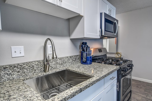 355 Kalanianaole St Unit 225, Hilo, HI 96720 - kitchen with white cabinetry, appliances with stainless steel finishes, dark wood-style floors, and a sink
