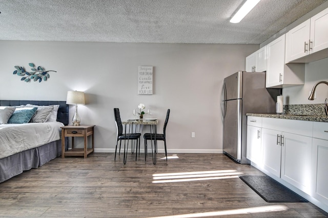 355 Kalanianaole St Unit 225, Hilo, HI 96720 - kitchen with white cabinets, dark wood-style flooring, a sink, a textured ceiling, and freestanding refrigerator