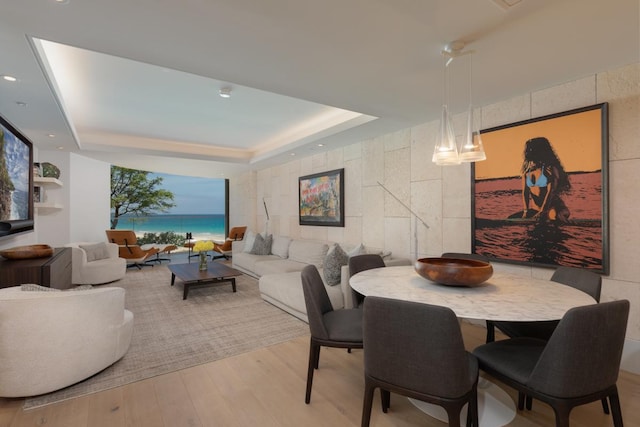 66-84 Kaunaoa Dr Unit A21, Kamuela, HI 96743 - dining room featuring a tray ceiling, light wood finished floors, a water view, and recessed lighting
