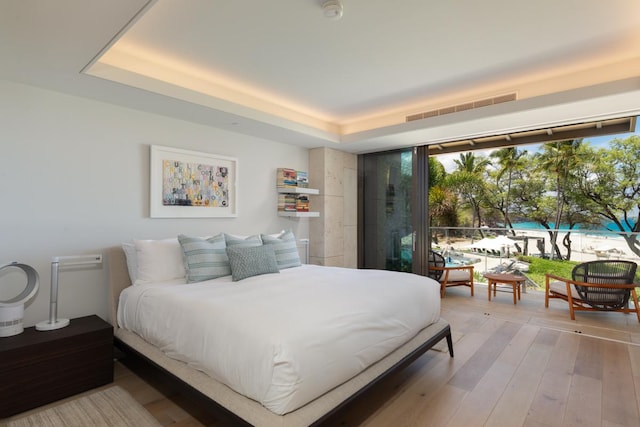 66-84 Kaunaoa Dr Unit A21, Kamuela, HI 96743 - bedroom featuring wood finished floors and a tray ceiling