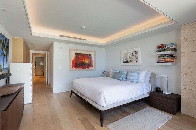 66-84 Kaunaoa Dr Unit A21, Kamuela, HI 96743 - bedroom with a tray ceiling and light wood-style flooring