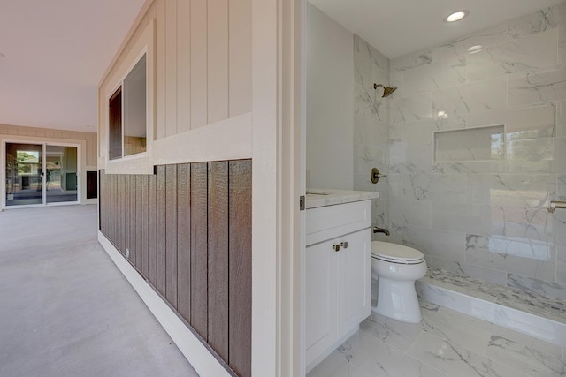 bathroom with vanity, recessed lighting, toilet, and tiled shower