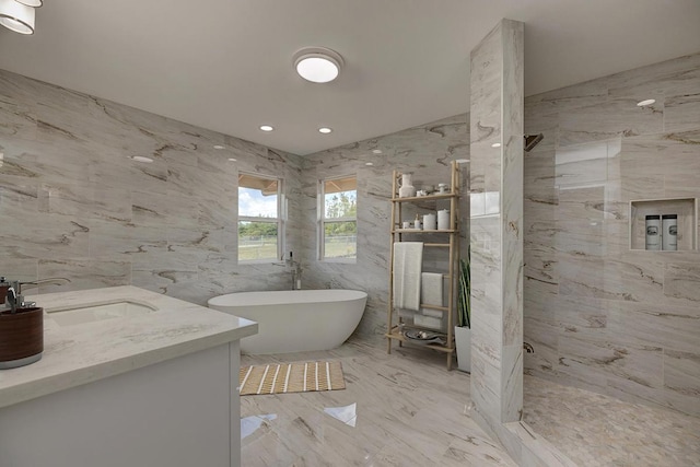 full bath featuring walk in shower, a sink, double vanity, marble finish floor, and a freestanding tub