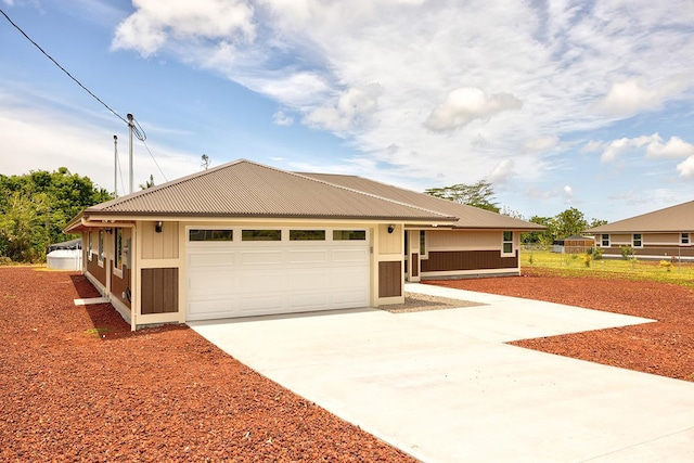view of front of property featuring fence, concrete driveway, and a garage
