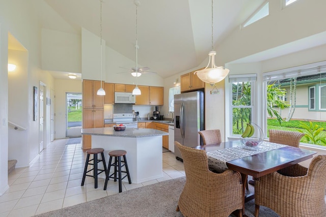 2110 Kaneka St Unit 73, Lihue, HI 96766 - kitchen featuring a kitchen island, high vaulted ceiling, a sink, and white appliances