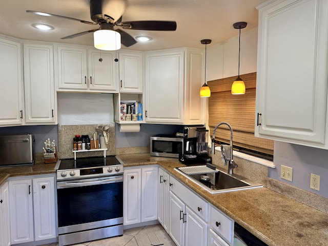 kitchen featuring appliances with stainless steel finishes, a sink, a ceiling fan, and white cabinetry
