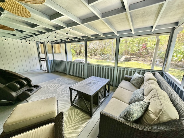sunroom / solarium with an outdoor living space and beamed ceiling