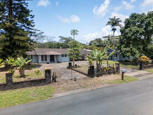 view of front of home featuring a fenced front yard and driveway