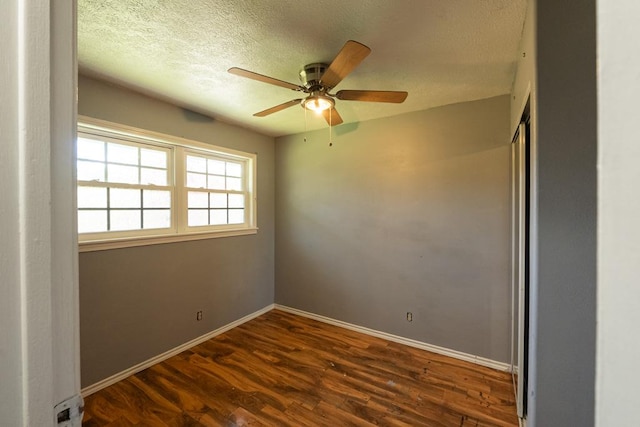 unfurnished room featuring a textured ceiling, baseboards, a ceiling fan, and wood finished floors