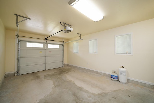 garage with a garage door opener and baseboards