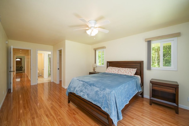 bedroom with light wood-style flooring, baseboards, and a ceiling fan