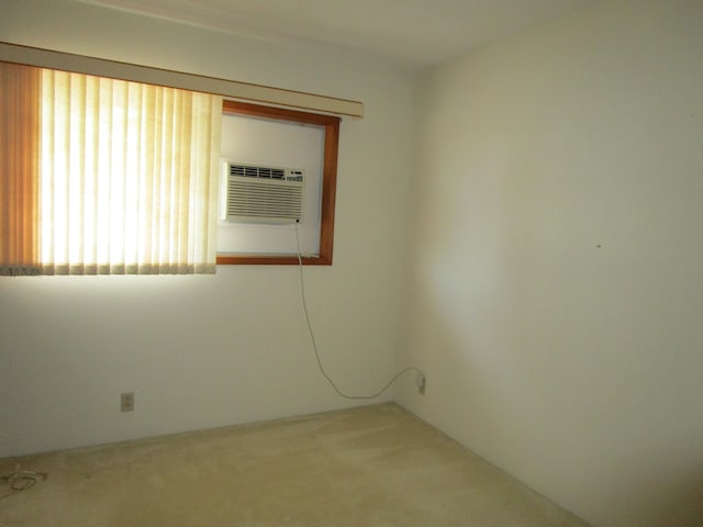 carpeted empty room featuring a wall mounted air conditioner