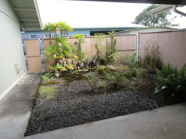 view of yard featuring fence and a gate