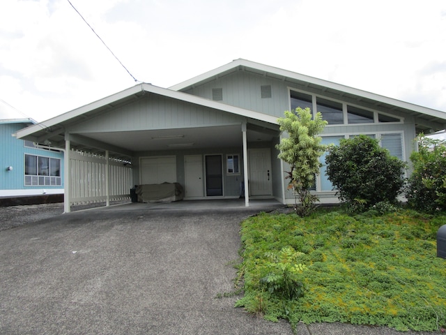 view of front of house featuring an attached carport and driveway