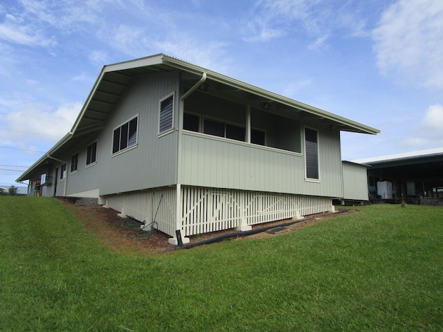 view of property exterior featuring a lawn