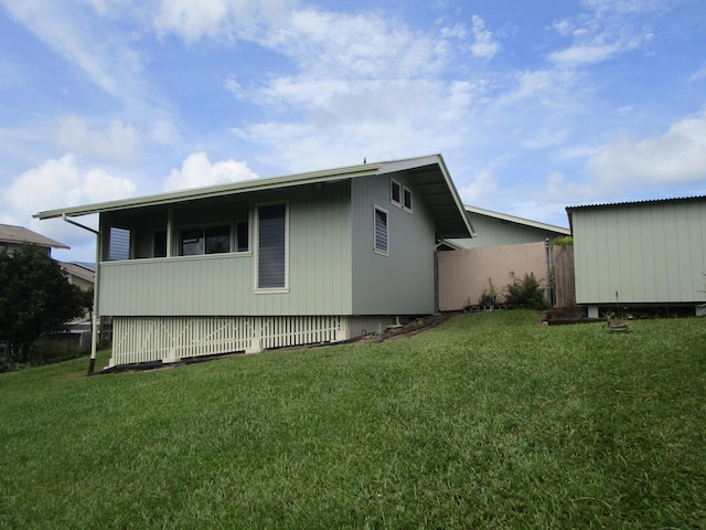 view of side of home featuring a lawn