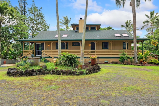 4429-A Kaluamakua Pl, Kilauea, HI 96754 - view of front of home featuring a shingled roof, a chimney, a porch, and a front yard