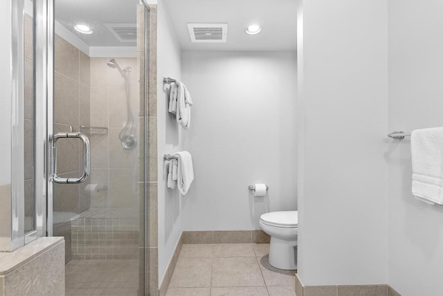 full bathroom featuring visible vents, a stall shower, baseboards, tile patterned floors, and toilet