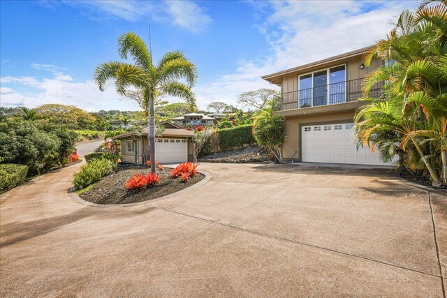 77-155 Kalaniuka St, Holualoa, HI 96725 - view of front facade featuring a garage, a balcony, and concrete driveway