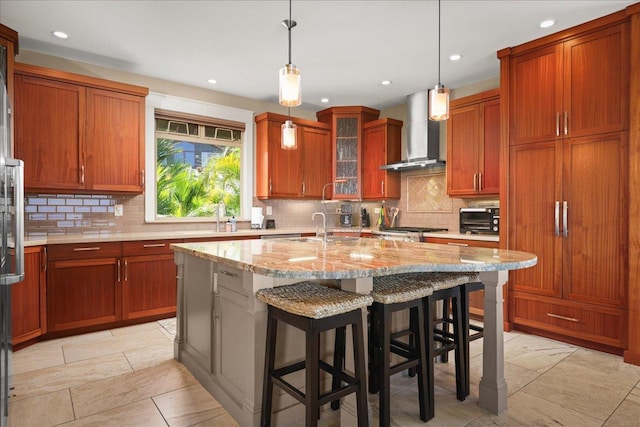 77-155 Kalaniuka St, Holualoa, HI 96725 - kitchen with wall chimney range hood, light stone countertops, decorative backsplash, and a kitchen island with sink