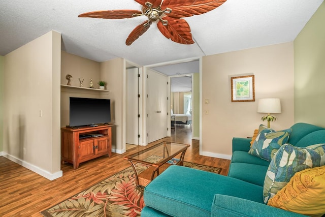 3811 Edward Rd Unit 1206, Princeville, HI 96722 - living area featuring a ceiling fan, wood finished floors, and baseboards